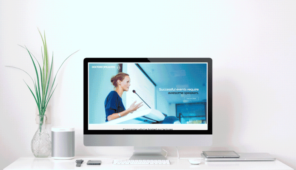 gif of website scrolling inside mockup of computer desk with monitor.